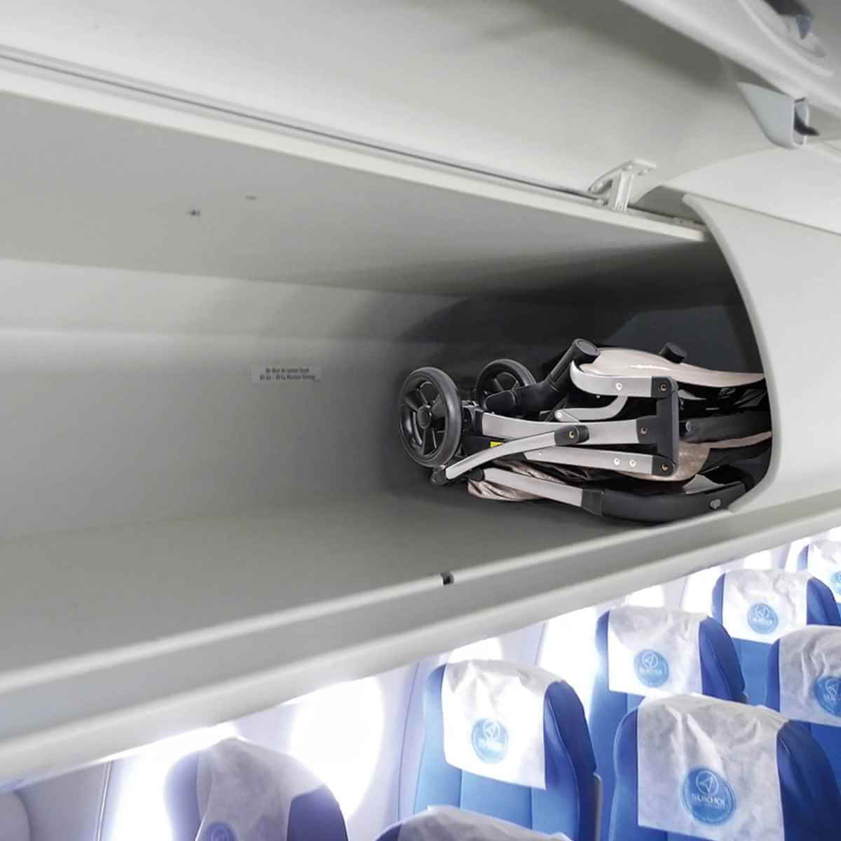 Folded Ibiyaya Evolution Speedy Fold pet stroller fitting easily inside an airplane overhead storage bin